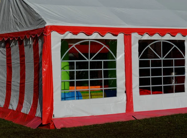 Sheets made of non-flammable materialPVC tarpaulin for trucks rear entrance equipped with zip windows made of transparent plastic Steel frame of the tent made of galvanized pipes, red, white stripes