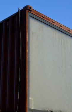 modular housing in stacked container cells. each module has a different function. large windows and rusty walls of rusty steel. restaurant light chains in park, screw stability, shipping
