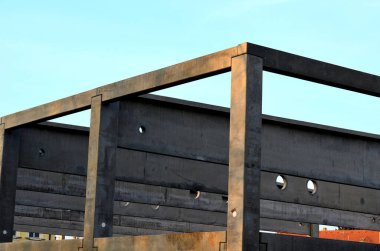 construction of concrete structure of industrial hall of warehouse. the concrete feeder arm from the mixer bends over the beams and columns. pipe conveyor on the crane.excavator, tractor, yellow