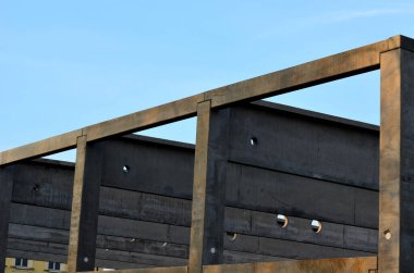 construction of concrete structure of industrial hall of warehouse. the concrete feeder arm from the mixer bends over the beams and columns. pipe conveyor on the crane.excavator, tractor, yellow