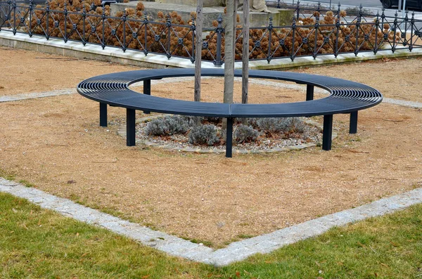 wire circular benches park furniture in winter. sintered gravel with the help of a vibrating roller. The permanently pleasant park surface of the historic square. levanula beds in the middle of the be