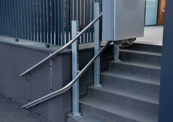 楼梯旁边有一个平台 上面有扶手 供无法通过楼梯障碍物的轮椅使用者使用 电梯把他们拉得更高一点 灰色栏杆 不锈钢 — 图库照片