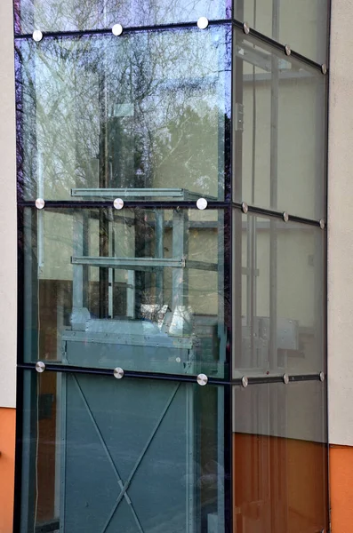 an outdoor elevator with a glass structure can be added to a historic house where it is not possible to carry out demolition work. you can see the cabin going up the transparent shaft