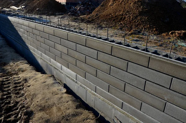 stock image holding a road notch of a bridge forecourt tunnel. retaining wall with concrete grouting is covered with fake, optically prettier wall. fencing with hollow bricks filled wires, railing,steel, soil