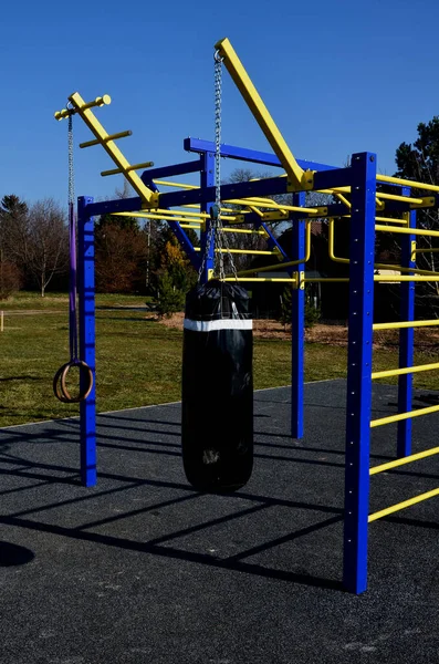 stock image training ground for boxing and a gym. exercises on gym rings, with ropes and ladders. a punching bag hangs here. men train the body, muscles. punching and kickboxing, lawn