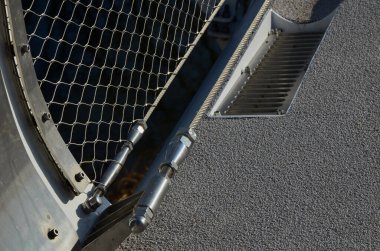 staircase and wide pedestrian bridge with perforated metal floor. galvanized sheet metal with circular holes. white railings like on a ship in the arch. handrail made of polished stainless steel pipe.