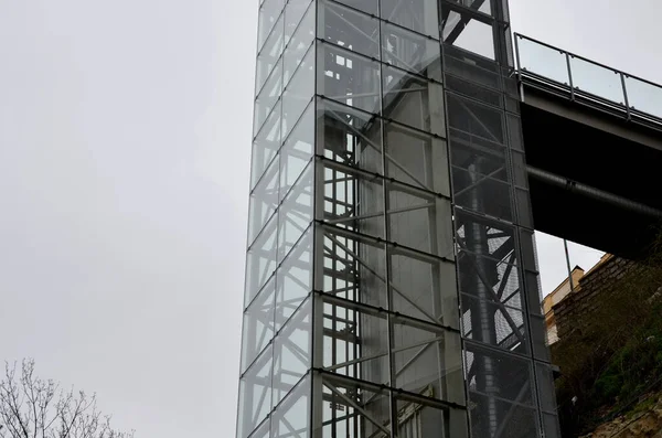 stock image an outdoor elevator with a glass structure can be added to a historic house where it is not possible to carry out demolition work. you can see the cabin going up the transparent shaft, rock, cliff