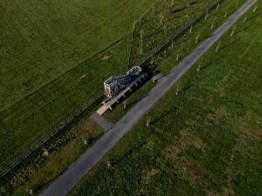 observation tower platform made of oak logs with barrier-free access for seniors and the immobile. zoo safari with a large paddock and terrace for tourists, aerial, high angle view, upper, education