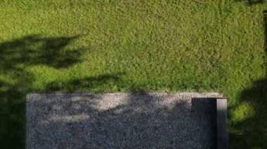 wooden oak prism bench in garden. for better drying of wood, grooves are milled lower part, which prevents tension and cracking of beam in park. side view, table tennis, fence rope, post, fir, abies