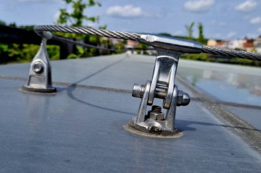 A lightning conductor is used to protect buildings from lightning that can damage a house or its electrical equipment is routed to the highest points of a green garden roof.