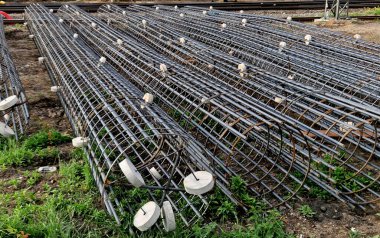 Kaynak yığınları için bir makinede takviye sepetleri üretimi. Binaların, köprülerin, yolların temellerinin uzunlamasına çelik çubuklar. Yeraltındaki depoya yerleştirilirler. beton