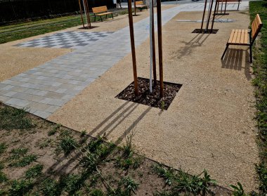 Bahçedeki ahşap meşe bankı. Odunların daha iyi kuruması için, oluklar alt kısımlarda değirmenlenir, bu da gerilimi ve park alanındaki kirişleri engeller. yan görünüş, masa tenisi, çit ipi, direk, boş zaman