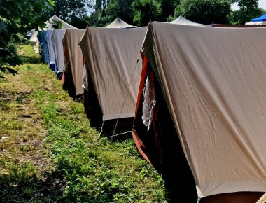 Birkaç çadır spor malzemesi olan bir çadır, yönetici ve bayan aşçılar için çadır. Çayırda kamp yapmak için uzun ve dayanıklı sığınaklar.