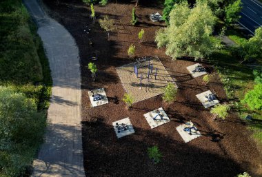 view of the exercise zone of the fit park. a new project to maintain a slim figure. gym muscles on the machine. movement exercise. running and stretching.above, morning clipart