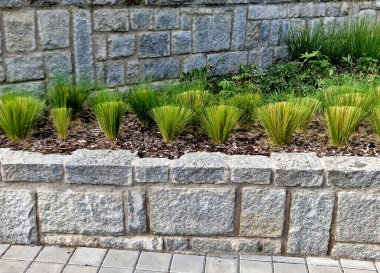 Taş bloklardan yapılmış granit duvarlar, bina duvarları veya oturma alanları, park ziyaretçileri için koltuklar gibi tasarım elementleri olarak hizmet vermektedir. Metal çerçeveli bisikletler ve yatay kablolardan oluşan banklar için park yeri