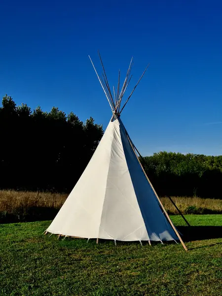 the teepee tent is equipped on the inside with furniture for groups of children in kindergarten. outdoor lessons combined with games in the meadow and drawing will not hurt, parasol, tarpaulin, beige