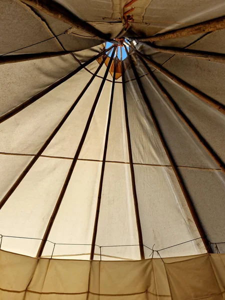 the teepee tent is equipped on the inside with furniture for groups of children in kindergarten. outdoor lessons combined with games in the meadow and drawing will not hurt, parasol, tarpaulin, beige