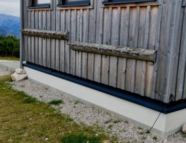 the ski center is equipped with ski racks. downhill tracks and the background of the ski resort. Simple board organizer with pins for separating skis from each other.