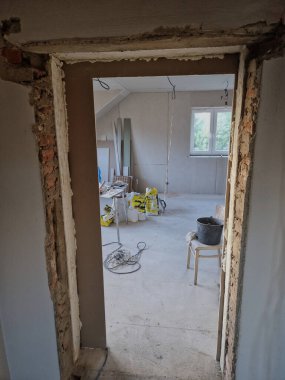 Alçıpan tavanı kurulumu. Çatı katında tavan ve duvar vidaları olan metal profillere vidalanıyor. Eklemler alçıyla sıvanmış, kablolar avizeye.