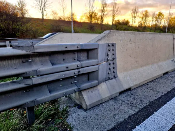 connection of metal and concrete highway barriers with screws. reinforcement with metal struts and tensioned bars in places where there is not  space between the lanes. noise barrier