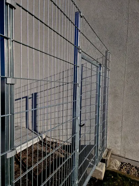 strong galvanized welded mesh fencing is used around industrial halls and logistics centers and airports. gate with handle and lock. durable and cheap parts can be quickly built anywhere