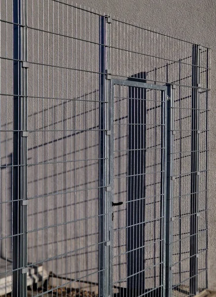 strong galvanized welded mesh fencing is used around industrial halls and logistics centers and airports. gate with handle and lock. durable and cheap parts can be quickly built anywhere