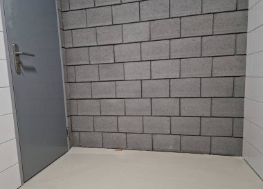 Gri beton bloklar. Amaçlı bir deponun duvarları. Saf dizaynlı bir garajın kapısı.