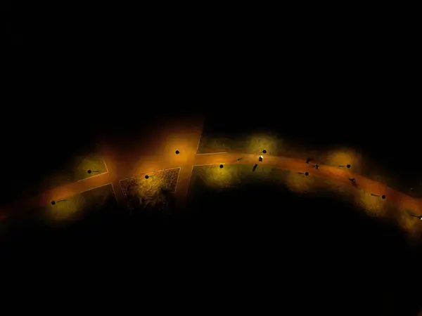 path through the mountains from a height, is lit by lamps at regular intervals in the bend. illumination is the orange color of the spectrum. evening landscape intimately tender