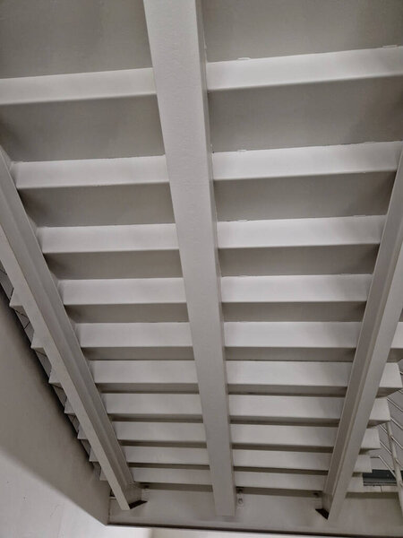 white painted staircase from below. buildings industrial sheet metal corridor. bottom side