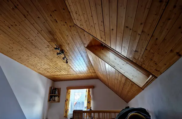 plank ceiling in the attic with spotlights. a sloped ceiling will give the room a lived-in feel. roof windows, wall, plaster, book, librairy, hostel, hotel, attic