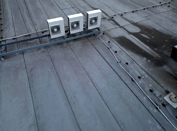The cooling units are industrial or air-conditioning, which are used in the summer for cooling the premises, with fans on the roof of the storage hall, mainly for industrial operations, high angle