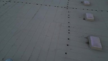 A lightning conductor is used to protect buildings from lightning that can damage a house or its electrical equipment is routed to the highest points of a green garden roof.