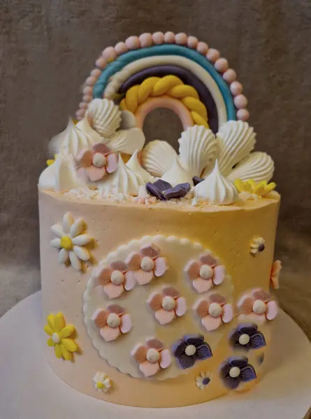 cake for a little girl or toddler. pastel colors and lots of flowers. on top are seashells and a rainbow. production according to the customer\'s imagination by the next day