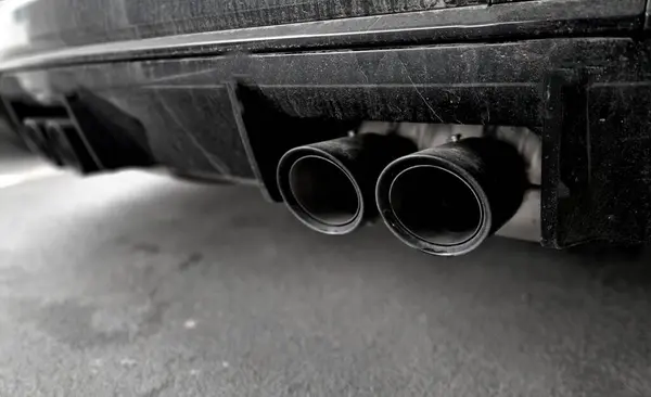 the carbon pressure wing of the car helps load the rear axle of the wheels to the road. sports homologated original modifications of cars. exhaust tip.