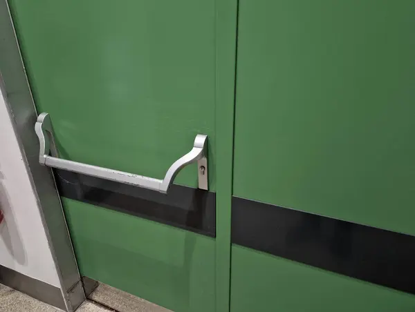 rear door of department store or warehouse with handle for quick release of door. evacuation door handle, panic fire button. in dangerous crush, all you have to do is lean horizontal pushing, push,