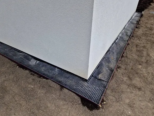 around the house it is always necessary to create a gutter path made of gravel and pebbles. serves to absorb water and ventilate the walls of the house. installation of curb steel sheets. membrane foil