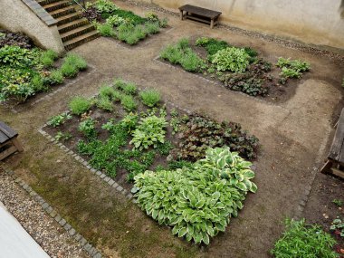Kemer bahçesinde dekoratif süslemeli metal kapılı bahçeye bahçedeki çiçeklerle birlikte tuğladan aşağı inen merdivenlerle giriliyor. Çarmıh şeklinde yolları olan manastır bahçesi, kare şeklinde. bir duvarla çevrili