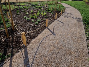 wooden oak prism bench in garden. for better drying of wood, grooves are milled lower part, which prevents tension and cracking of beam in park. side view, table tennis, fence rope, post, fir, abies