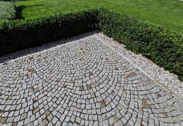 stock image cut squares of flowerbed edging in a historic garden made of boxwood hedges. courtyard of castle along cobblestone path row of squares frozen ice, snowing  evergreen topiary, ivy, creeper, above, top