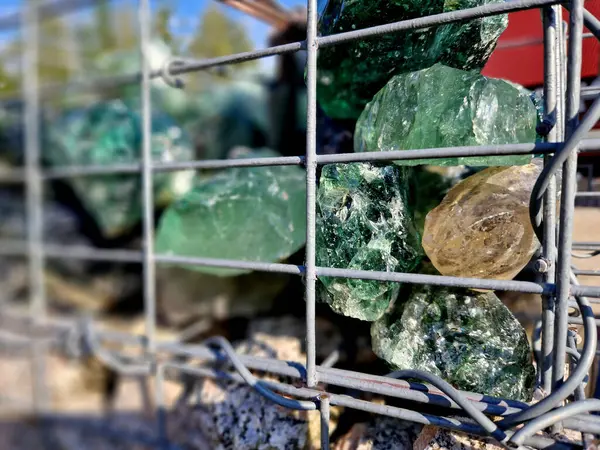 stock image gabion baskets are filled stones with colored glass lumps. in the case of backlighting at night, a tasteful decoration in the garden is created