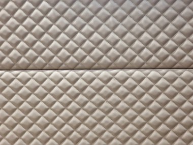 an upholstered wall with a quilted pattern. thread pattern, lining with a pattern and a raised surface in a checkered shape clipart