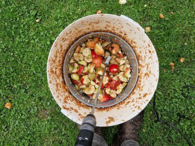 Making homemade cider juice from fallen apples pressing in a hand press with a screw children help to turn the handle cider flows out of the pulp through a sieve the pulp is thrown to the compost clipart