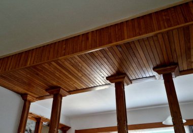 Evin koridorundaki ahşap sütunlar. Yunan tarzı sermaye. Portico 'lu koridor. Tavanı tahtalarla kaplamak