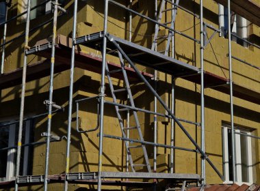 repair of the facade of the house. The scaffolding is covered with a blue transparent net made of plastic fabric. protects settlers as well as pedestrians so that pieces of concrete bricks and objects