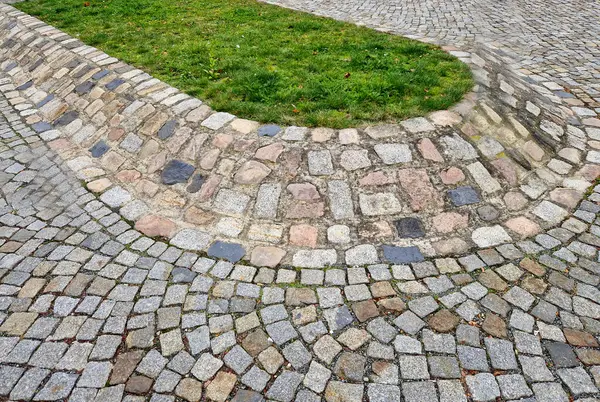 Tepenin tepesinde çimleri olan asfalt bir ada. Şeritleri ayırır ve çimenleri kışın tuzlanmaktan korur..