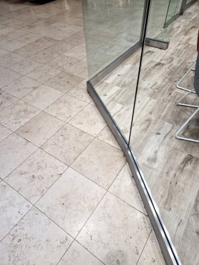 frameless glass door. glazed partitions have special hinges and handles. everything is drilled into the glass and attached with stainless steel screws. polished bar handle clipart