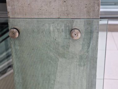 Cam, camı delmek için tasarlanmış vida ve çamaşır makineleriyle duvara tutturulmuş. Kaplama, istasyon binasında bir korkuluk ve hava bölümüdür.