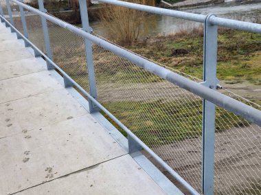 Terrace fencing, railings of metal pipes filled with steel cables cable mesh. fencing wire stainless steel fence. wooden floor, dance floor in the park, wire, galvanized railings, railing