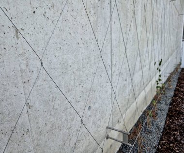 Balkonlu ön cephede tüm binayı kaplayan gergin bir kablo ağı var. Elektrik gerilim yalıtıcıları. Binanın köşeleri kemer şeklinde, yuvarlak. Örgülü ağ. Çakıl, saman, ağaç kabuğu.