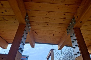 terrace with wooden pergola and plexiglass roof. vines are straining, crawling under the beams. garden or park. sitting with dry wall wine region. restaurant countryside france, truss